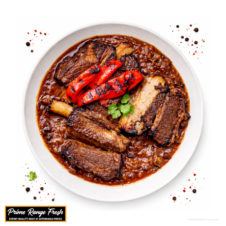 Stewed meat with red peppers on a white plate, featuring Prime Range Fresh branding.